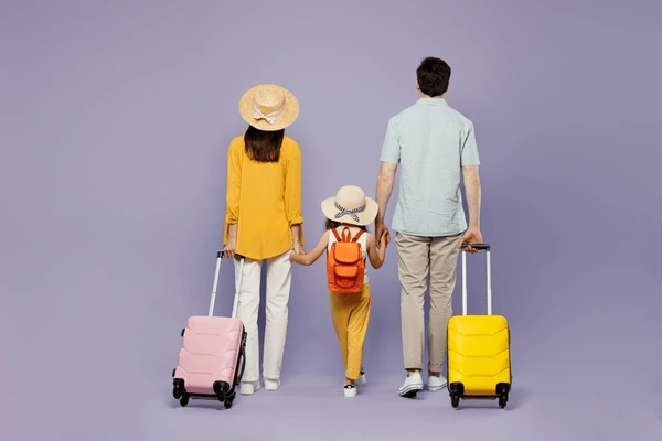 Back view of a family with a child looking out at a scenic travel destination.